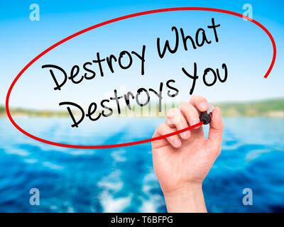 Man Hand writing Destroy What Destroys You with black marker on visual screen. Stock Photo