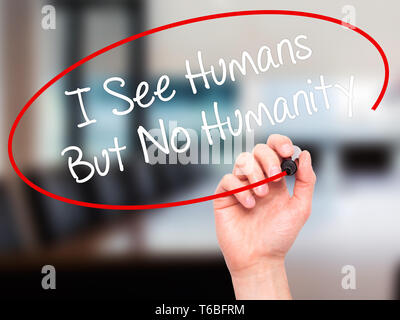 Man Hand writing I See Humans But No Humanity with black marker on visual screen. Stock Photo
