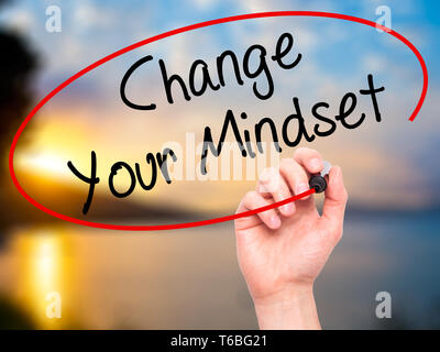 Man Hand writing Change Your Mindset with black marker on visual screen. Stock Photo