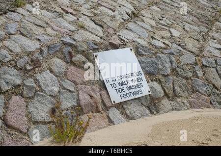 Warning sign on path  affected by coastal erosion Stock Photo