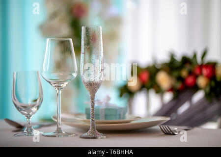 Wedding table decoration. Festive table setting with decorated glasses and dishes. Three decorated glasses and dishes on wedding table. Stock Photo
