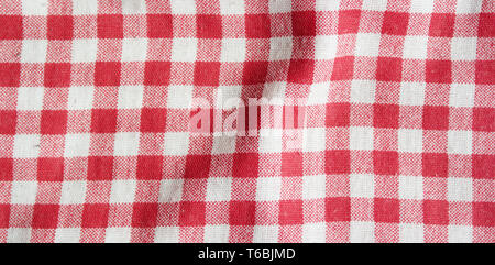 Red linen picnic tablecloth. Texture of checkered picnic blanket. Stock Photo