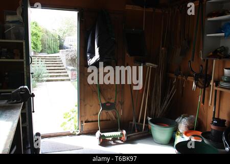 Inside a shed with the door open letting light in Stock Photo
