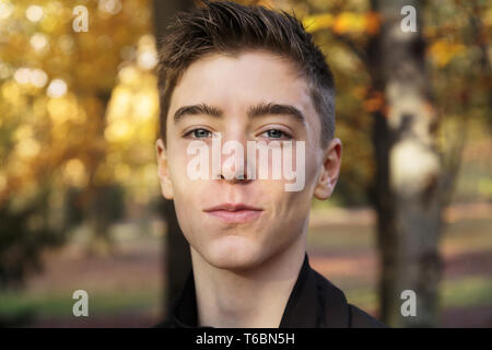 portrait of a teenage boy with autumn booked Stock Photo