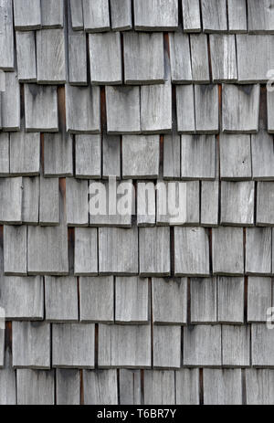 Backgrounds and textures: weathered wooden shingles, exterior wall or roof of rustic building Stock Photo