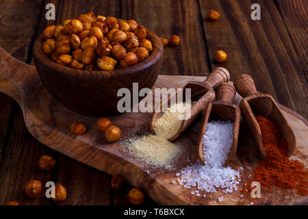Roasted spicy chickpeas on rustic background Stock Photo