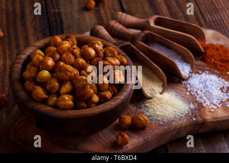 Roasted spicy chickpeas on rustic background Stock Photo