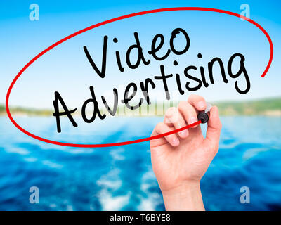 Man Hand writing Video Advertising with black marker on visual screen Stock Photo