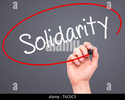 Man Hand writing Solidarity with black marker on visual screen ...