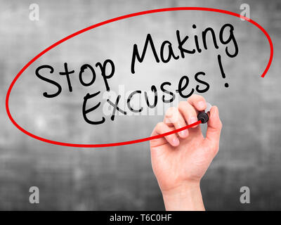 Man Hand writing Stop Making Excuses with black marker on visual screen Stock Photo