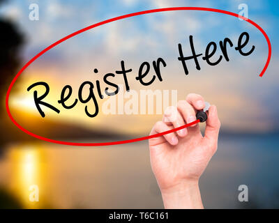 Man Hand writing Register Here with black marker on visual screen Stock Photo