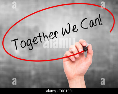Man Hand writing Together We Can! with black marker on visual screen Stock Photo