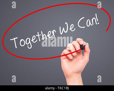 Man Hand writing Together We Can! with black marker on visual screen Stock Photo