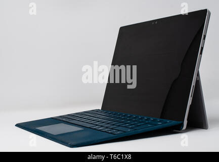 Reading, United Kingdom - April 19 2019:   A side on view of a Microsoft Surface Pro 4 tablet laptop hybrid Stock Photo