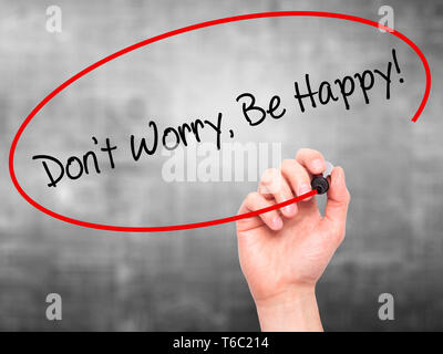 Man Hand writing Don't Worry, Be Happy! with black marker on visual screen Stock Photo