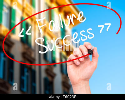 Man Hand writing Failure Success with black marker on visual screen Stock Photo