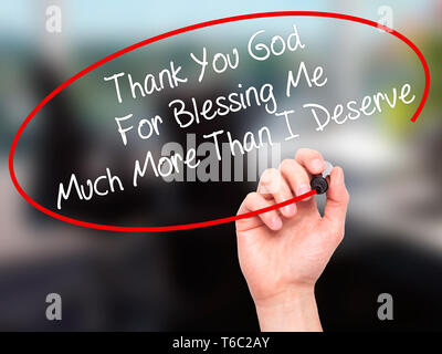 Man Hand writing Thank You God For Blessing Me Much More Than I Deserve with black marker on visual screen Stock Photo