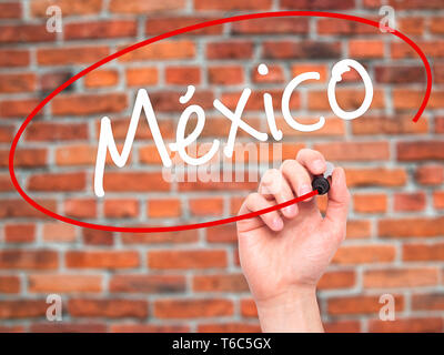 Man Hand writing Mexico (In Spanish) with black marker on visual screen. Stock Photo