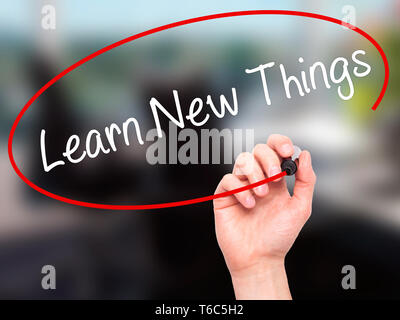 Man Hand writing Learn New Things with black marker on visual screen Stock Photo