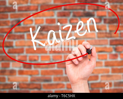 Man Hand writing Kaizen with black marker on visual screen Stock Photo