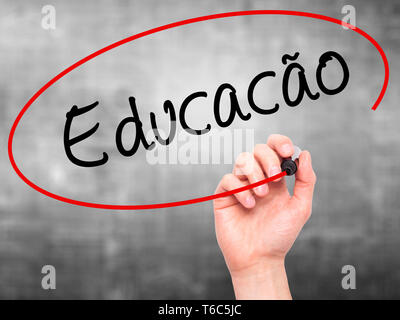 Man Hand writing Education (Educacao in Portuguese) with black marker on visual screen Stock Photo