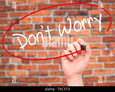 Man Hand writing Don't Worry with black marker on visual screen Stock Photo