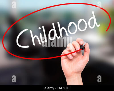 Man Hand writing Childhood with black marker on visual screen Stock Photo