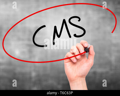 Man Hand writing CMS (Custom Management System) with black marker on visual screen Stock Photo