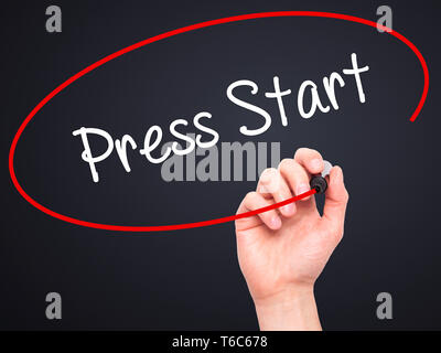 Man Hand writing Press Start with black marker on visual screen Stock Photo