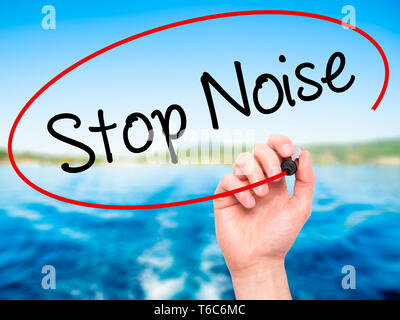 Man Hand writing Stop Noise   with black marker on visual screen Stock Photo