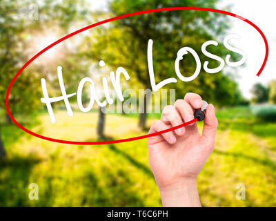 Man Hand writing Hair Loss with black marker on visual screen Stock Photo