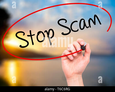 Man Hand writing Stop Scam with black marker on visual screen Stock Photo