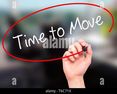 Man Hand writing Time to Move with black marker on visual screen Stock Photo