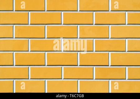 Brick wall background - new bricks wall pattern. Texture brick wall of yellow color Stock Photo