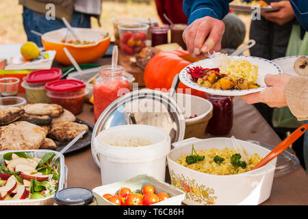 Group of people having lunch outdoors. Group of people having lunch outdoors. Stock Photo