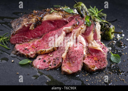 Barbecue aged Wagyu Tagliata di Manzo with lambs lettuce as close-up on ...