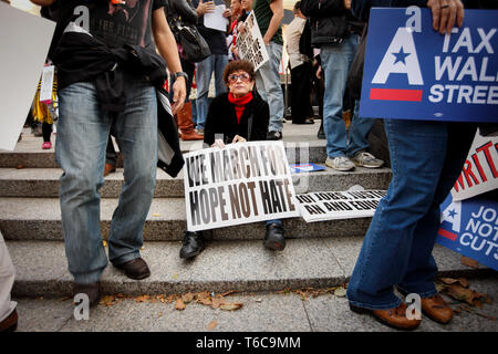 A protester joining the demonstration orchestrated by Occupy Wall Street. Her sign reads 'We march for hope not hate'. The Occupy Wall Street demonstrated against financial greed and inequality and questioned the ethics of the financial business. Stock Photo