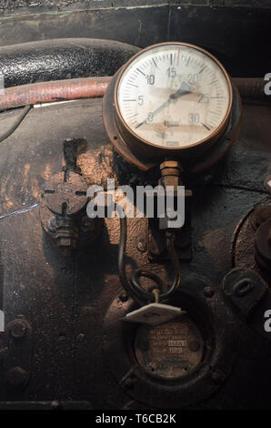 Grungy details of gauge in steam train Stock Photo