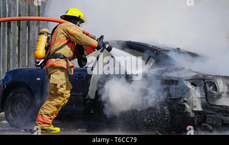 Montreal, Canada,April 10, 2019.Fireman putting out an automobile fire.Quebec,Canada.Credit:Mario Beauregard/Alamy Live News Stock Photo