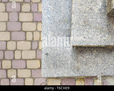 View from above of gray granite stairs leading to colorful pavement outdoors in town, free space for text Stock Photo