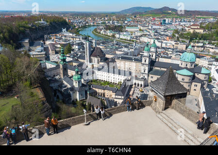 Austria tourism, view of tourists on the viewing terrace of Salzburg Castle (Hohensalzburg) looking down at the baroque Old Town area of the city. Stock Photo