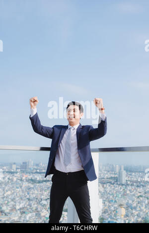 Businessman raising his arms opening palms with face looking up Stock Photo