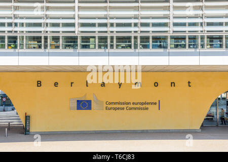 Front view of a pillar of the Berlaymont building in Brussels, Belgium, bearing the logo and name of the European Commission in black letters.