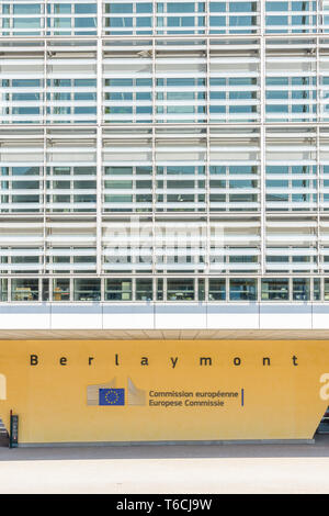 Front view of a pillar of the Berlaymont building in Brussels, Belgium, bearing the logo and name of the European Commission in black letters. Stock Photo