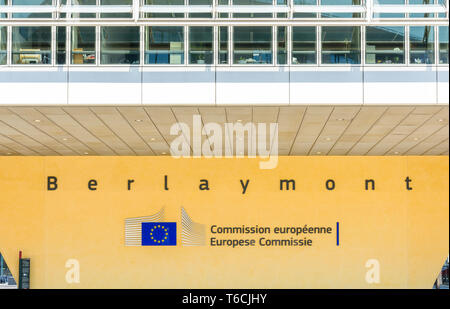 Front view of a pillar of the Berlaymont building in Brussels, Belgium, bearing the logo and name of the European Commission in black letters. Stock Photo