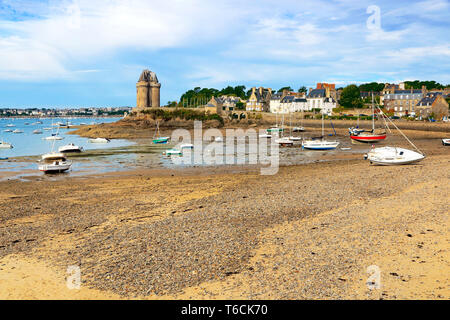 Beach with moored boats facing the Solidor tower in Brittany, France. Stock Photo