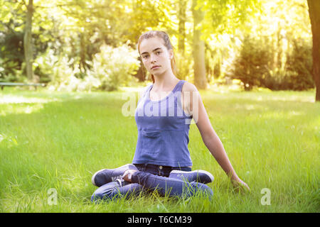 portrait of a young woman making yoga in the nature Stock Photo