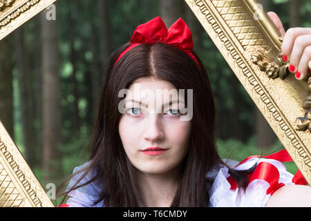 Young woman with picture frame Stock Photo
