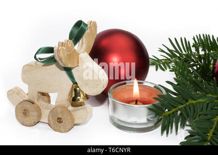 Christmas animal figure with candle and red balls against white background Stock Photo