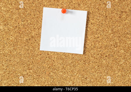 Cork board with pinned blank notepaper. Stock Photo